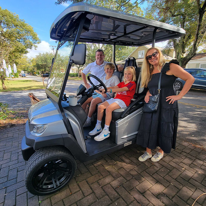 A Family of four enjoying their brand new Bintelli Beyond 4 Seater street legal golf cart in Titanium